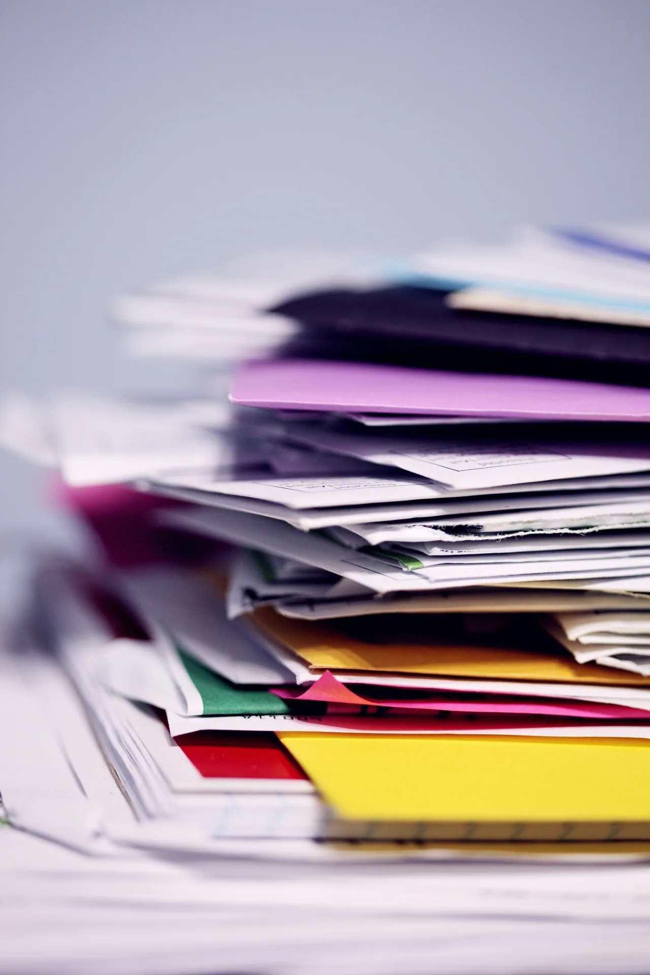 Stack of scattered papers and folders in different colors
